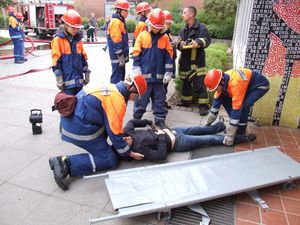 Eine Person wurde vom Angriffstrupp aus dem Gebäude gebracht und wird jetzt zur Verletztensammelstelle getragen.